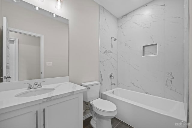 full bathroom featuring toilet, hardwood / wood-style flooring, vanity, and tiled shower / bath