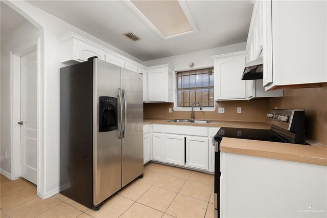 kitchen with white cabinetry, sink, stainless steel refrigerator with ice dispenser, range with electric stovetop, and light tile patterned floors