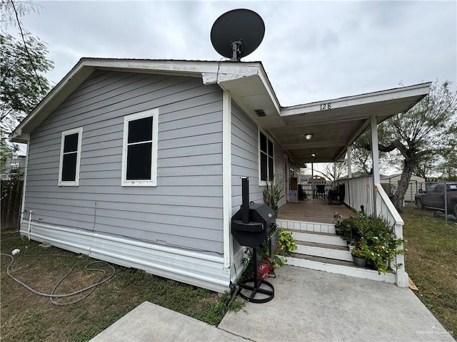 view of side of home with a wooden deck