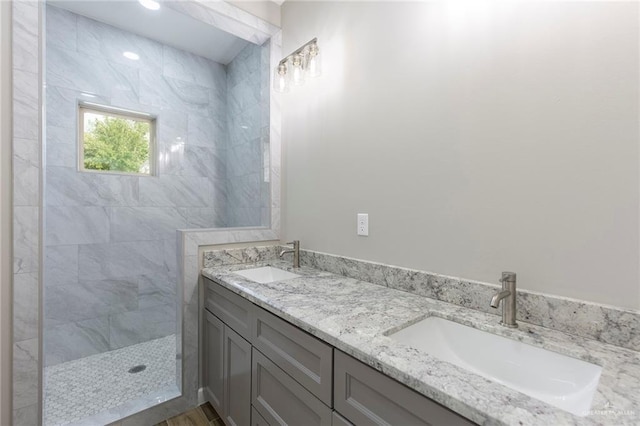 bathroom featuring vanity and tiled shower