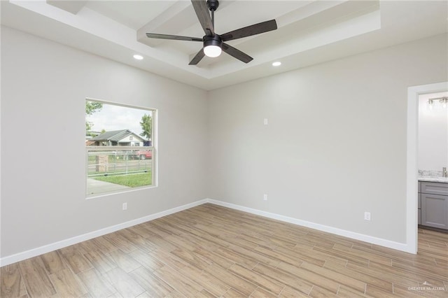 empty room with ceiling fan and light wood-type flooring