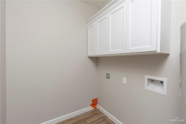 laundry area featuring hardwood / wood-style floors, hookup for an electric dryer, cabinets, and hookup for a washing machine