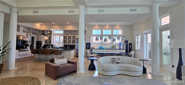 6518 Beach Dr, South Padre Island, TX 78597 - living area featuring ornate columns, a towering ceiling, and recessed lighting