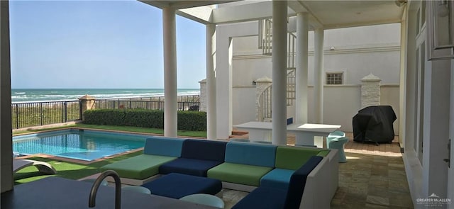 6518 Beach Dr, South Padre Island, TX 78597 - view of patio / terrace featuring outdoor lounge area, grilling area, view of water and beach, and a fenced backyard