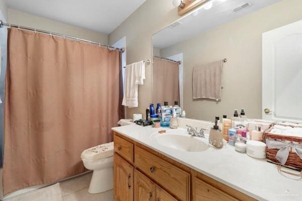 1501 Lookout St, Edinburg, TX 78541 - full bathroom featuring toilet, vanity, tile patterned flooring, and a shower with shower curtain