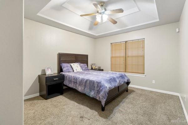 1501 Lookout St, Edinburg, TX 78541 - carpeted bedroom with a tray ceiling, baseboards, and a ceiling fan