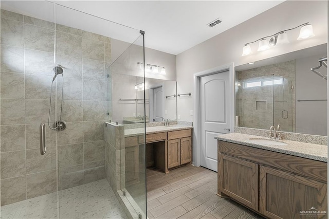 bathroom with vanity and an enclosed shower