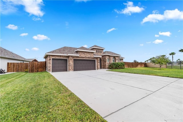 view of front of house with a garage and a front lawn