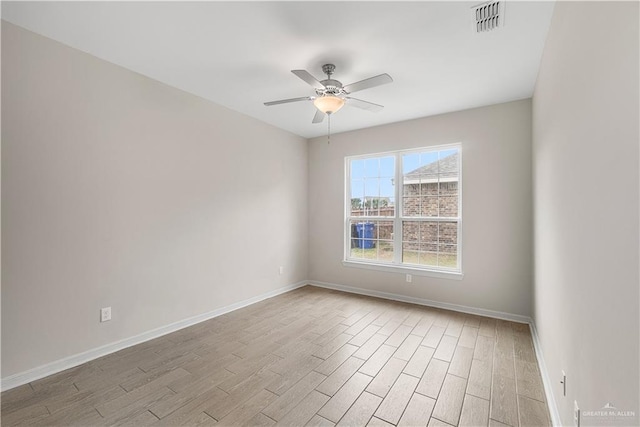 empty room with ceiling fan and light hardwood / wood-style floors