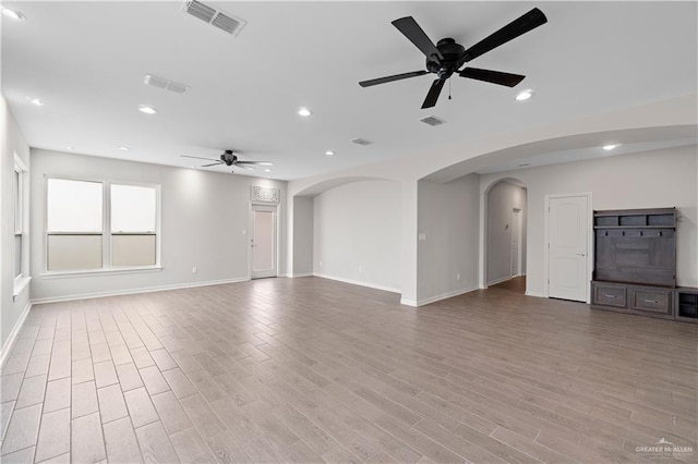 unfurnished living room featuring light hardwood / wood-style flooring and ceiling fan