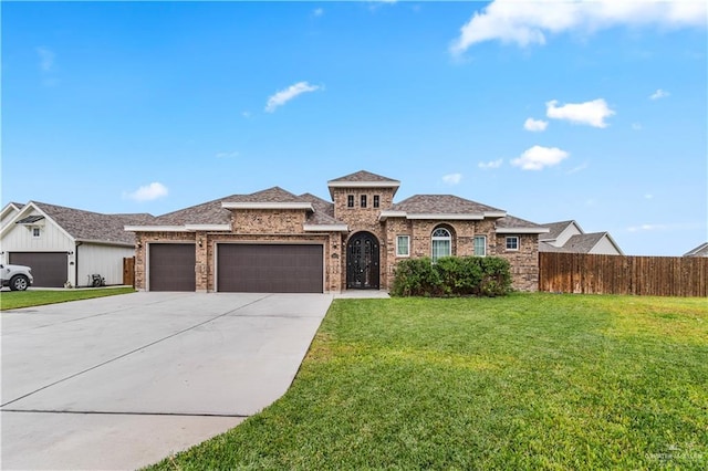 view of front of home with a front yard and a garage