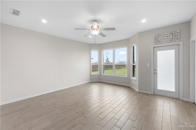 spare room featuring ceiling fan and light hardwood / wood-style floors