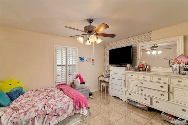 bedroom with light tile patterned floors, baseboards, ceiling fan, and wallpapered walls