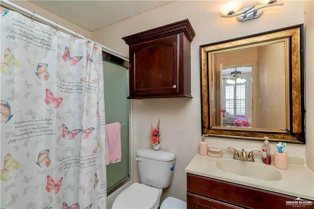 bathroom featuring toilet, a shower with curtain, and vanity