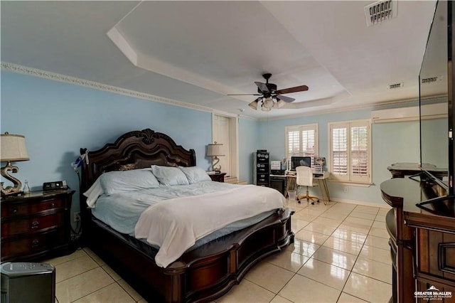 bedroom with a tray ceiling, light tile patterned flooring, a ceiling fan, and visible vents