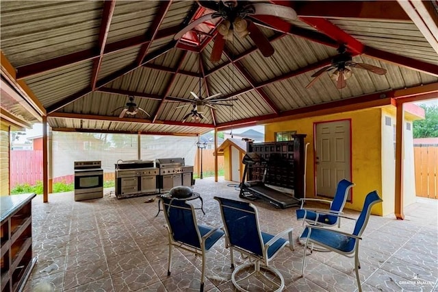 view of patio with a gazebo, an outdoor kitchen, a fenced backyard, and a grill