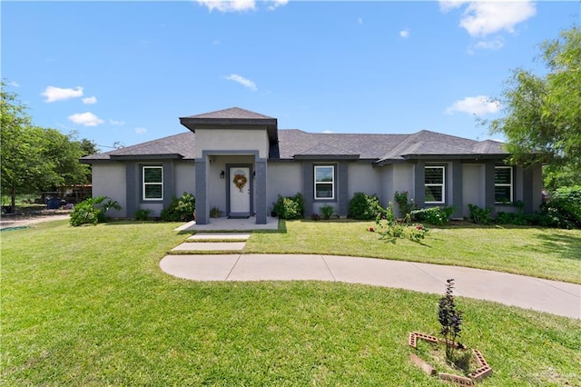 16311 Citrus Dr, Mcallen, TX 78541 - prairie-style home with stucco siding, a front yard, and roof with shingles