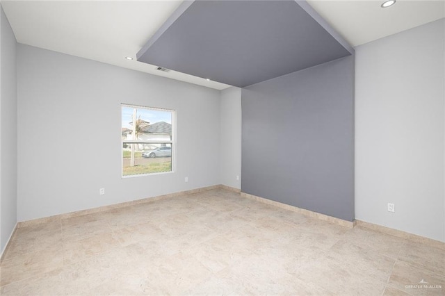 empty room with recessed lighting and baseboards