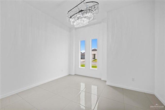 unfurnished room featuring baseboards and tile patterned flooring