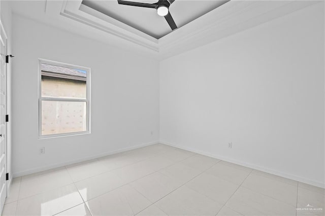 unfurnished room featuring baseboards, light tile patterned floors, a ceiling fan, and a tray ceiling