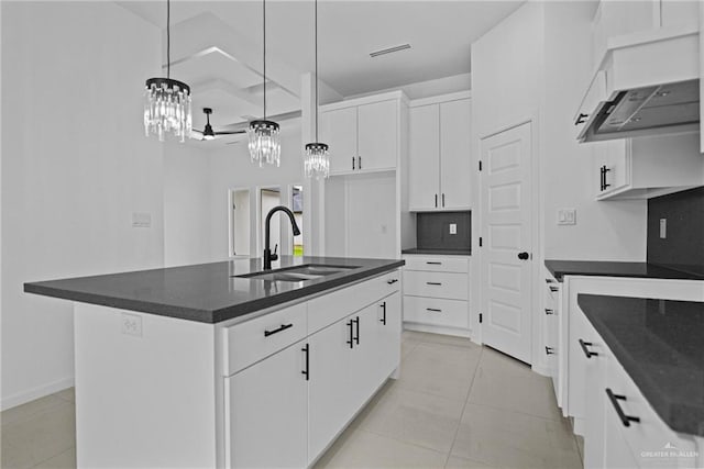 kitchen with pendant lighting, a sink, white cabinetry, light tile patterned floors, and custom exhaust hood