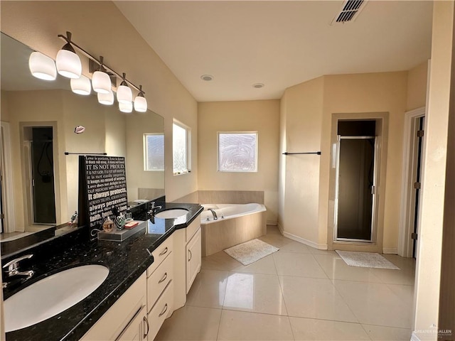 bathroom featuring tile patterned flooring, vanity, and plus walk in shower