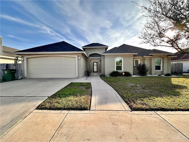 ranch-style home with a garage and a front lawn