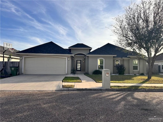 ranch-style home with a garage and a front lawn