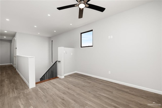 unfurnished room featuring recessed lighting, baseboards, and wood finished floors