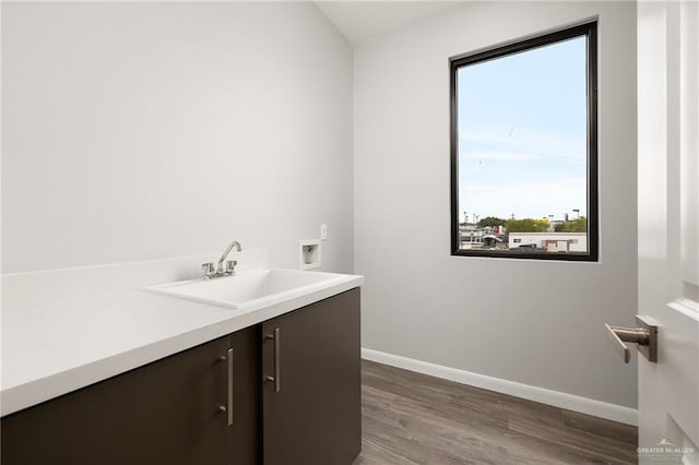 bathroom with vanity, baseboards, and wood finished floors