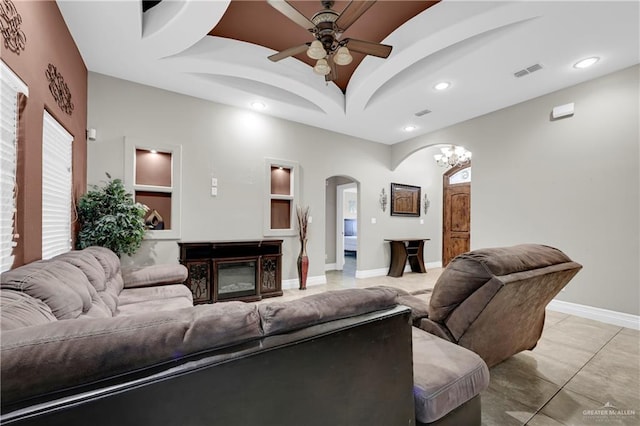 living room featuring ceiling fan with notable chandelier