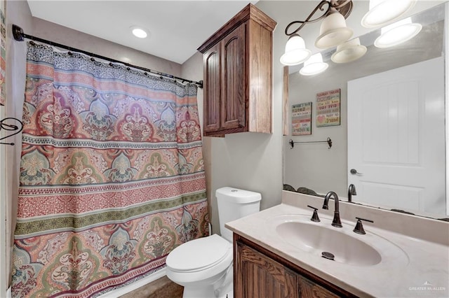 bathroom featuring a shower with curtain, vanity, and toilet