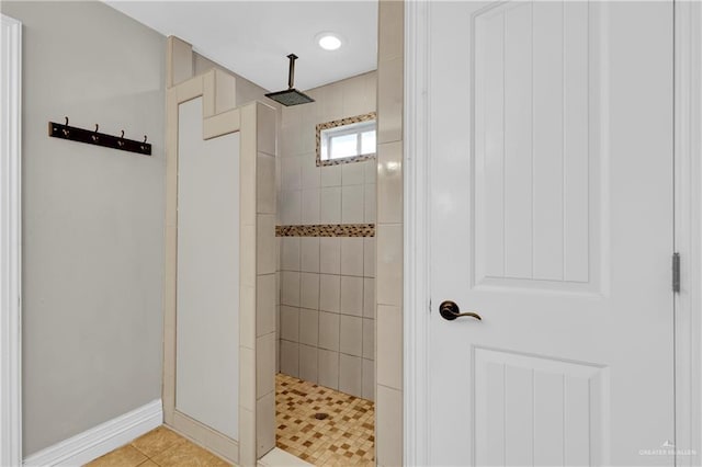 bathroom featuring tile patterned floors and a tile shower