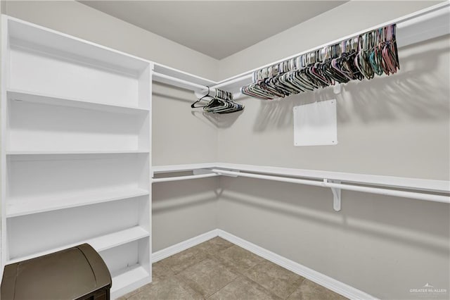 walk in closet featuring tile patterned flooring