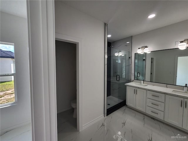 bathroom with a shower with door, vanity, and toilet