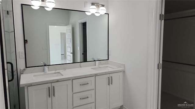 bathroom with vanity and a chandelier