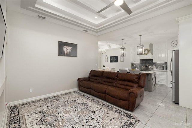 10312 N 31st St, Mcallen, TX 78504 - living room with a tray ceiling, a chandelier, a ceiling fan, and recessed lighting