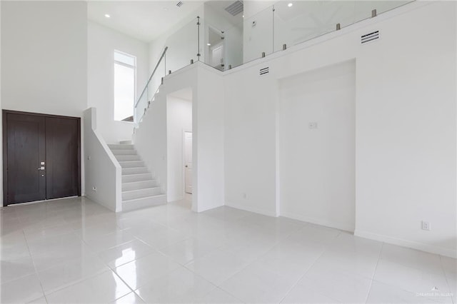 701 Helen St, Mission, TX 78574 - unfurnished room featuring stairway, a high ceiling, baseboards, light tile patterned floors, and recessed lighting