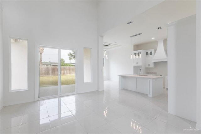 701 Helen St, Mission, TX 78574 - unfurnished living room with a sink, light tile patterned floors, and a high ceiling