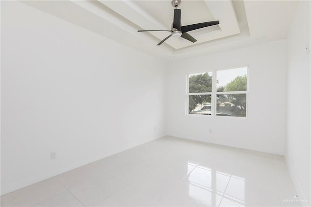 701 Helen St, Mission, TX 78574 - empty room featuring a tray ceiling, light tile patterned floors, and a ceiling fan