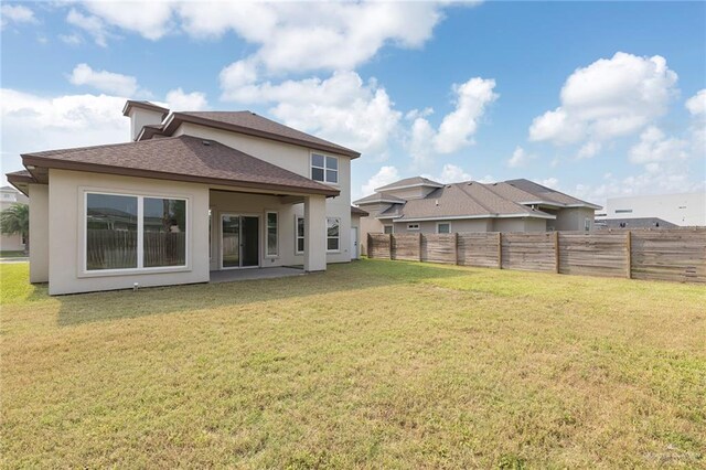 701 Helen St, Mission, TX 78574 - rear view of house with stucco siding and a shingled roof