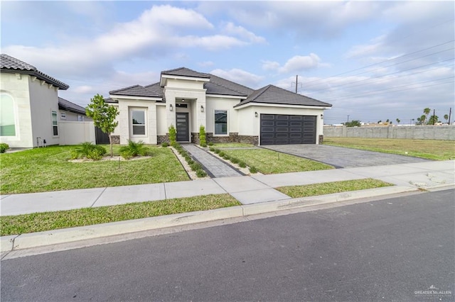 view of front facade featuring a front yard and a garage