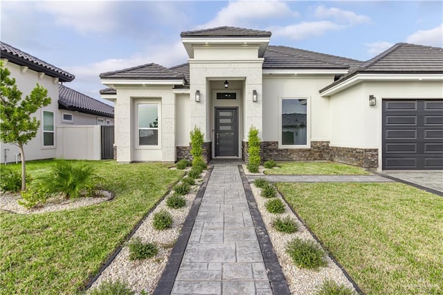 view of front of property with a front yard and a garage