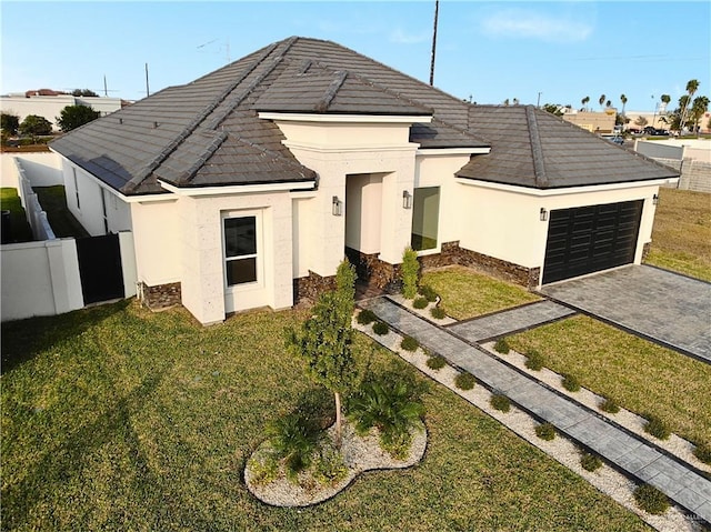 view of front of house with a garage and a front lawn