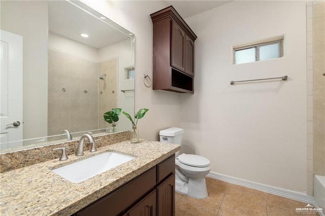 bathroom featuring tile patterned flooring, vanity, toilet, and a tile shower