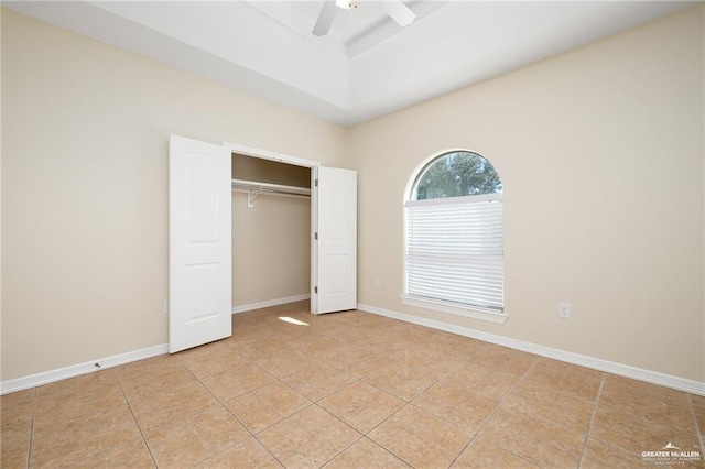 unfurnished bedroom with ceiling fan, a closet, and light tile patterned floors