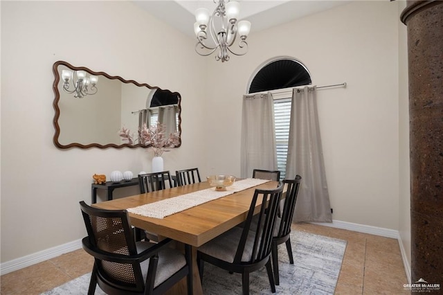 tiled dining space featuring a chandelier