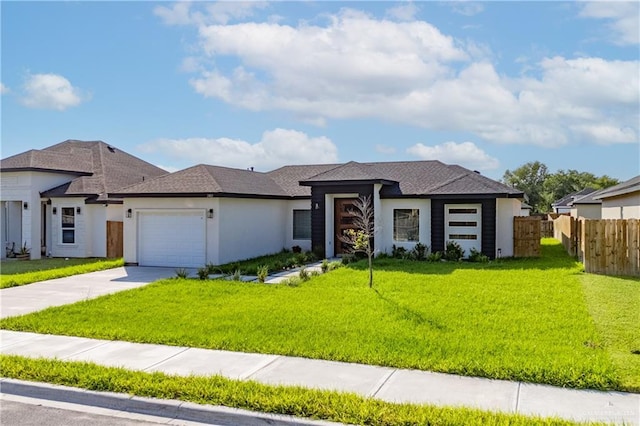 view of front of property featuring a garage and a front yard