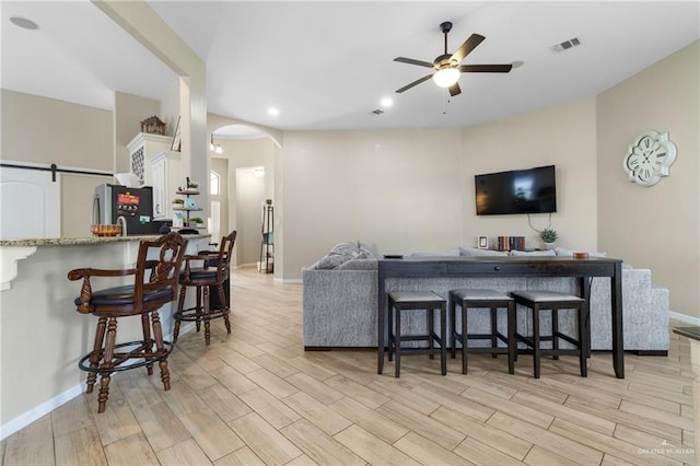 2003 N 44th Ln, Mcallen, TX 78501 - living area featuring ceiling fan, light wood finished floors, arched walkways, baseboards, and recessed lighting