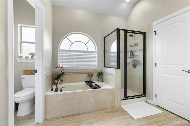 2003 N 44th Ln, Mcallen, TX 78501 - bathroom featuring a bath, toilet, a shower stall, and wood finished floors